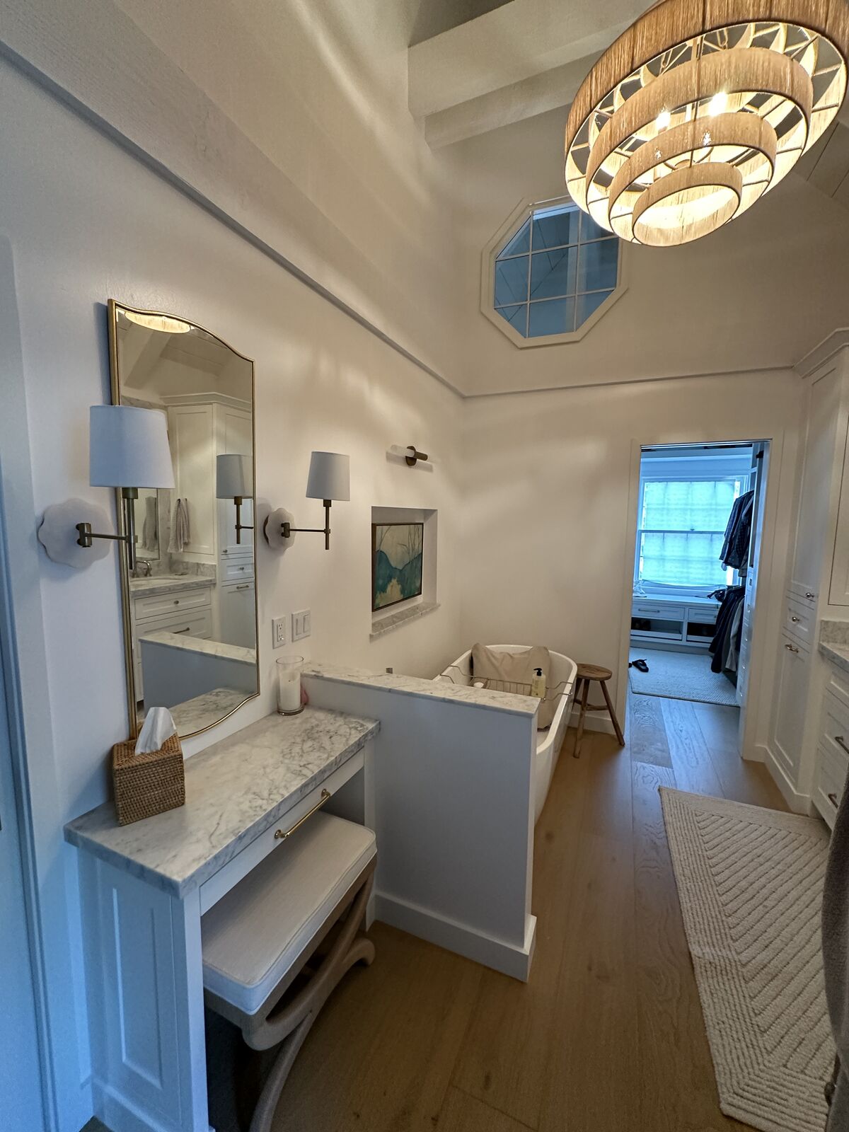 Completed PRDI bathroom with vaulted ceiling, chandelier, and custom makeup vanity